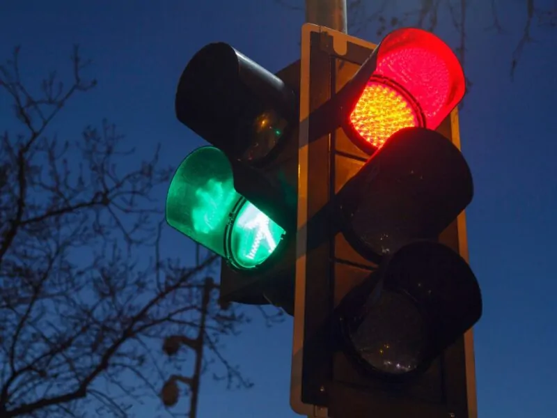 at a red traffic light with a green arrow